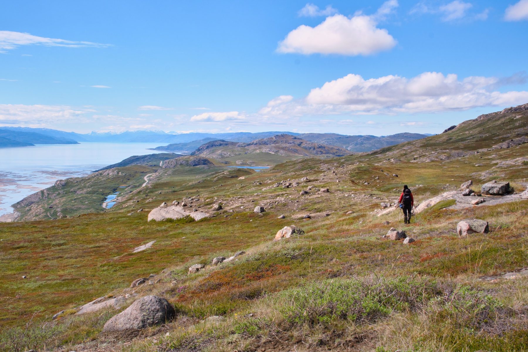 Hikers along the Kangerlussuaq Ridge with the fjord to the left